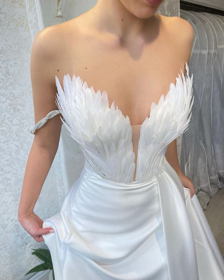 A Dress With Feathers Sweeping The Floor